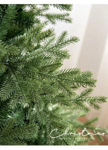 Close-up of dense mixed needles on a luxury pre-lit artificial Christmas tree branch