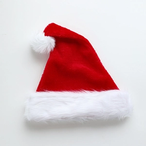 Classic red and white plush Christmas hat with soft fur trim and pom-pom for winter festive