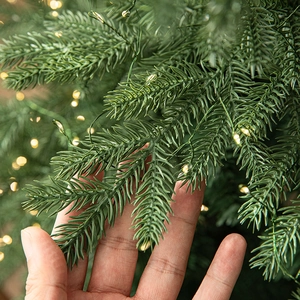 Luxury lush pre-lit Christmas tree with dense mixed foliage and warm LED lights