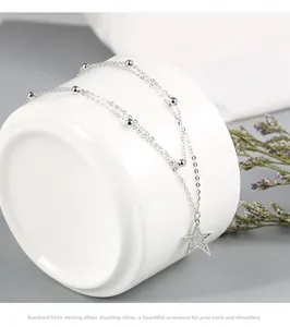 Macro detail of S925 sterling silver double-layer necklace with a zircon star pendant