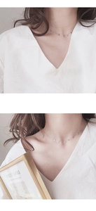 Close-up of minimalist silver chain necklace featuring multiple delicate cross pendants