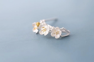 Detailed macro shot of S925 silver cherry blossom ring with matte petals and gold stamens