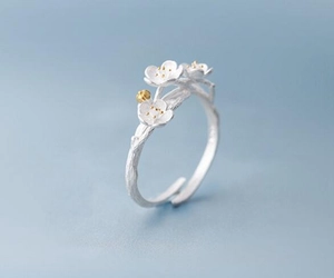 Macro shot of 925 silver open ring featuring frosted plum blossoms and branch texture