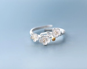 Detailed macro view of S925 sterling silver ring featuring branch texture and plum blossoms
