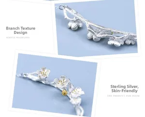 Macro shot of sterling silver branch texture and plum blossom necklace details