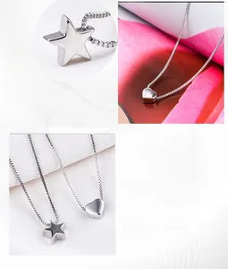 Detail of s925 silver necklace featuring polished heart and star pendants on box chain