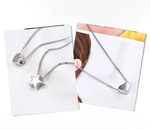 Detailed close-up of s925 silver heart and star pendants on refined box chains