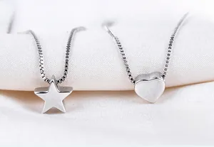 Detailed macro view of S925 silver star and heart pendants on elegant box chains