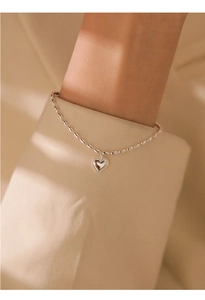Close-up of s925 silver rice bead chain bracelet with a 3D textured heart pendant