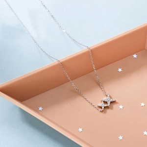Detailed close-up of S925 silver double star pendant with sparkling zircon inlays