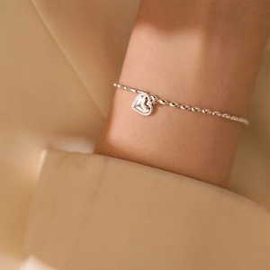 S925 sterling silver heart charm bracelet with delicate bead chain on woman wrist