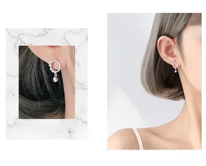Macro detail and on-model shot of S925 silver circle earrings with starry crystal pendants