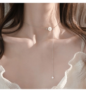925 sterling silver daisy necklace with seashell petals and asymmetric tassel on a model