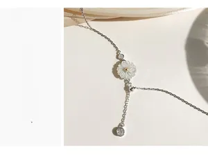 Detailed macro view of S925 silver daisy pendant necklace with golden center and clear zircons