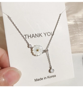 Detailed close-up of 925 sterling silver daisy pendant necklace with crystal accents