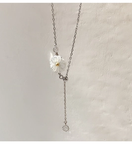 Detail of 925 sterling silver chain with shell daisy pendant and shiny zircon stones