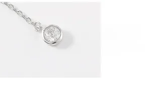 Macro shot of S925 sterling silver necklace featuring a round cubic zirconia pendant