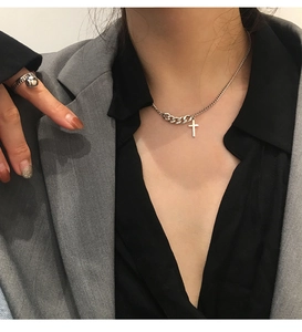 Vintage 925 sterling silver cross necklace with mixed chain design on grey blazer model