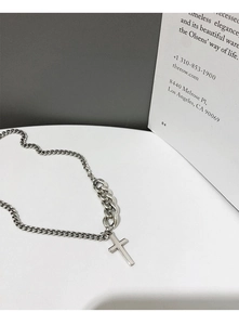 Detail of vintage 925 silver cross necklace with mixed cuban and link chain design