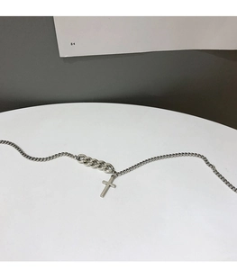 Close-up of vintage 925 silver cross pendant necklace with mixed link chain design