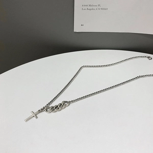 Detailed macro view of the 925 silver cross pendant and mixed texture chain links