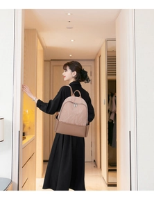 Close-up of lightweight brown backpack with pleated texture and leather splicing for women