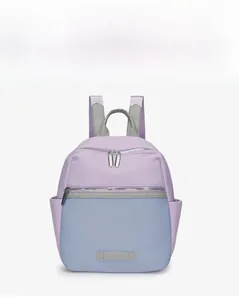 Detail of purple and blue-grey oxford fabric backpack with dual silver metal zippers