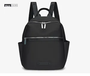 Front view of black waterproof nylon backpack with dual zippers and leather handle