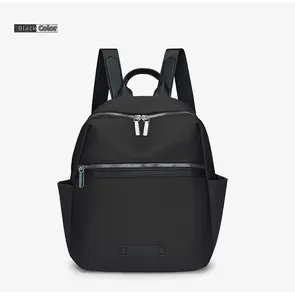 Front view of black oxford fabric backpack with silver metal zippers and side pockets