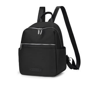 Detail view of durable black oxford backpack featuring dual front zippers and side pockets