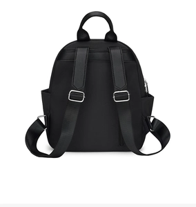 Detail view of the backpack back featuring anti-theft zipper pocket and Oxford cloth texture