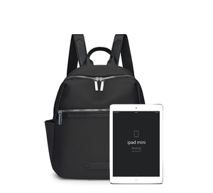 Mini black oxford backpack shown next to an iPad mini for size comparison