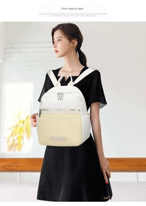 Detail of a minimalist two-tone oxford cloth backpack with silver metal zipper and straps