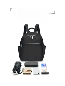 Detail view of large capacity black nylon backpack with various daily essentials displayed