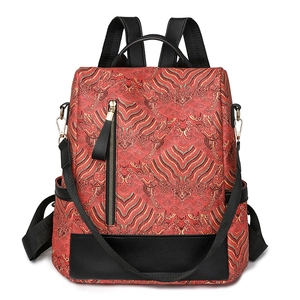 Ethnic style backpack with red gold traditional patterns and black leather detailing