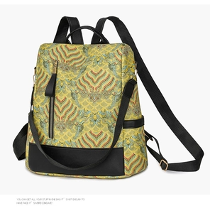 Close-up of yellow ethnic backpack with wave patterns and leather reinforced bottom