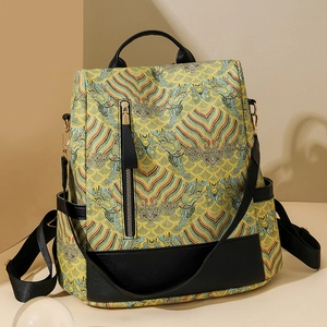 Detail of traditional Chinese wave pattern on backpack with black leather trim and gold zippers
