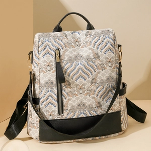 Detail view of ethnic wave patterns and vertical zipper pocket on stylish backpack