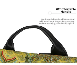 Detail of wide leather handle and traditional cloud pattern jacquard fabric on the bag