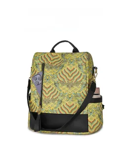 Detailed view of yellow printed backpack showing multiple functional exterior pockets
