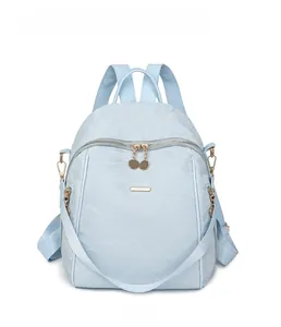 Front view of a light blue Oxford fabric backpack featuring elegant golden hardware details