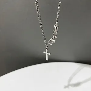 Retro asymmetric silver chain necklace with minimalist cross pendant on modern background