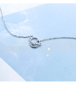 Macro view of S925 silver planet necklace with star-shaped cubic zirconia pendant