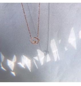 Macro shot of rose gold planet and star pendant with sparkling crystals on a fine chain