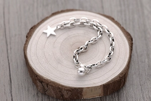 Close-up of S925 sterling silver star pendant and round bead on thick link chain