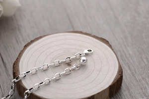 Detail of S925 sterling silver chain with lobster clasp and round bead pendant