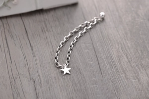 Detailed close-up of a s925 sterling silver hollow star charm on a double-layer chain
