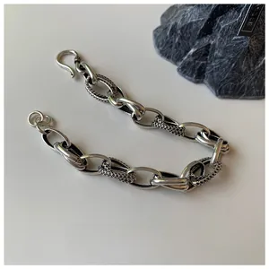Detailed macro view of vintage Thai silver chain bracelet with textured twisted links