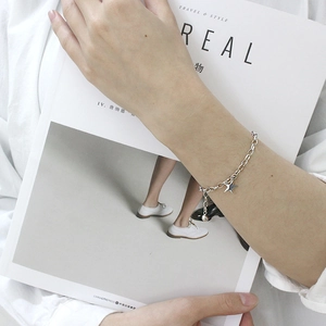 Minimalist S925 sterling silver star charm bracelet on model with Cereal magazine background