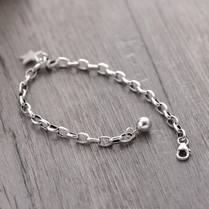 S925 sterling silver star charm bracelet with lobster clasp on grey wooden background